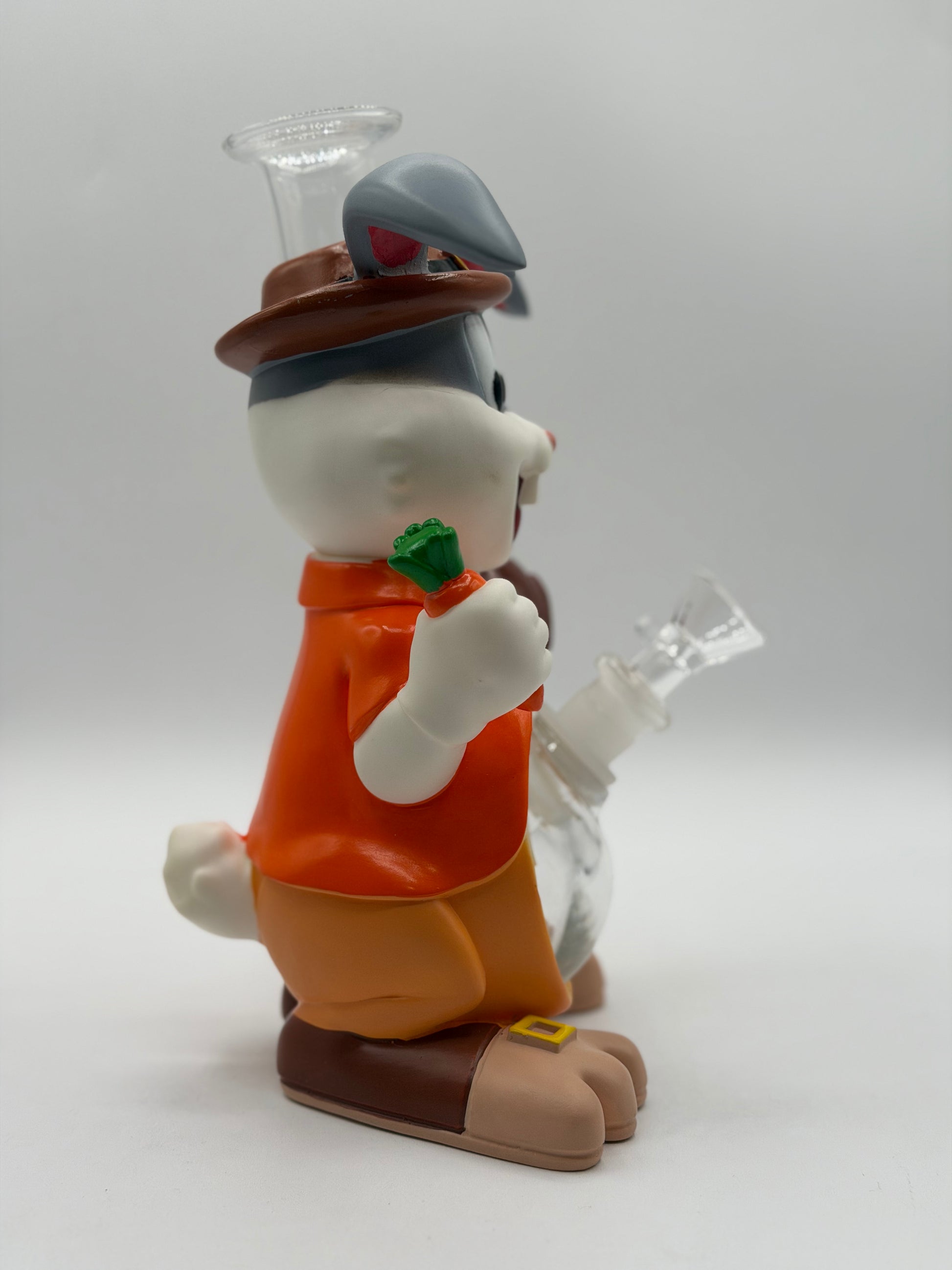 Animated character figurine holding a carrot with a white background