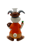 Animated character figurine with a white face, orange shirt, and brown pants on a white background