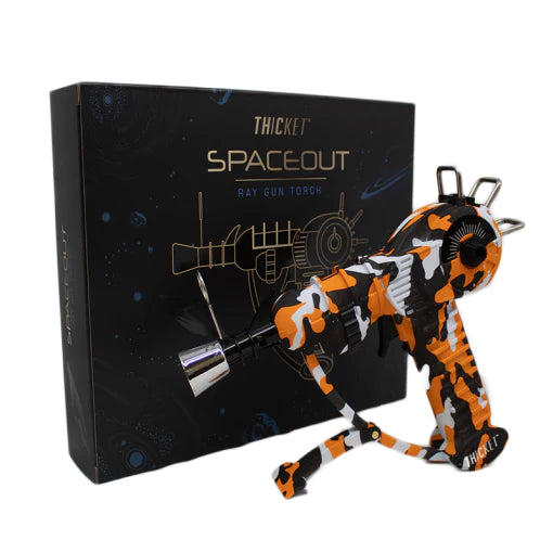 Get the THICKET SPACEOUT - CAMO RAYGUN Torch Lighter in bulk! A top-selling novelty with real performance, perfect for cannabis accessories wholesale and smoke shops.